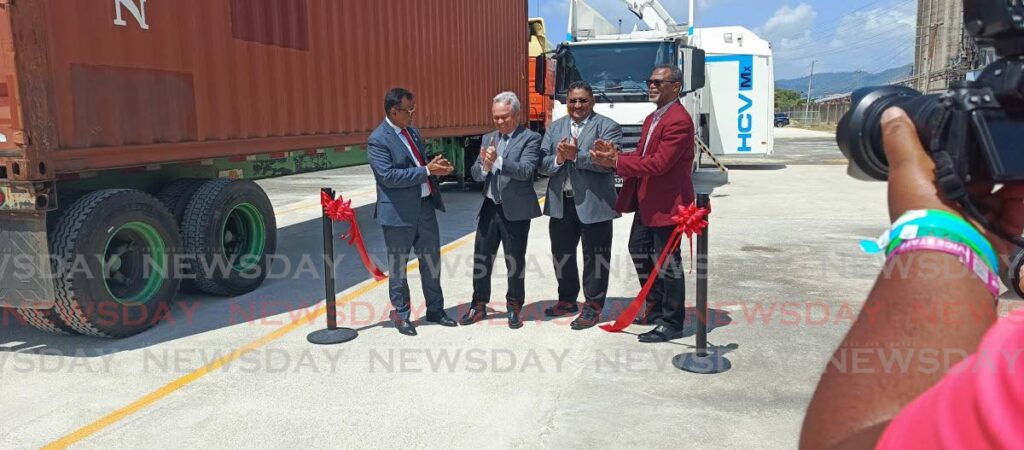 Works and Transport Minister Rohan Sinanan, left, Finance Minister Colm Imbert, Customs and Excise Comptroller Riad Juman and Port Authority chairman Colonel (ret'd) Lyle Alexander, celebrate the commissioning of two new mobile container scanners at the Port of Port of Spain, on February 25.  - Photo by Andrew Gioannetti