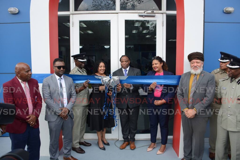 Minister in the Ministry of National Security Keith Scotland, centre, cuts the ribbon at the reopening of the Brasso Police Station on February 26. Looking on are, from left councillor John Lezama, Couva/Tabaquite/Talparo chairman Ryan Rampersad, Acting Commissioner of Police Junior Benjamin, Tabaquite MP Anita Haynes-Alleyne, councillor Sharen Badal-Ahyew and vice-chairman of the Couva/Tabaquite/Talparo Regional Corporation Henry Awong. - Photos by Innis Francis