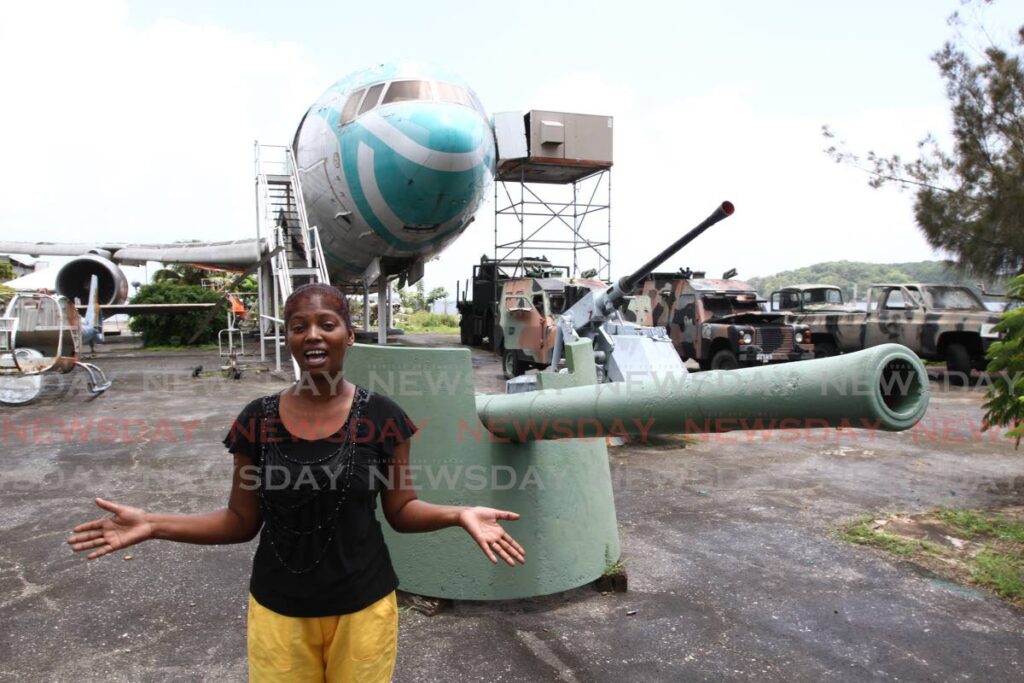 Tour guide Natasha Harris at the Chaguaramas Military History and Aviation Museum stands in front of some of the museum's assets in September 2013. The Chaguaramas Development Authority has served the museum an eviction notice effective February 28. - File photo