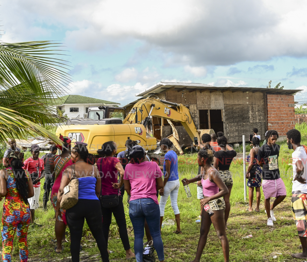 Ramjattan Trace, Arima residents look on in disbelief as their illegally constructed homes were demolished by order of the Commissioner of State Lands on February 6.