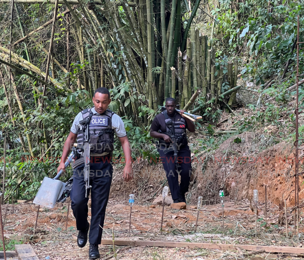 Police officers follow up a report of human remains being found at Riverville Trace, Dibe, St James on February 8. - Photo by Enrique Rupert