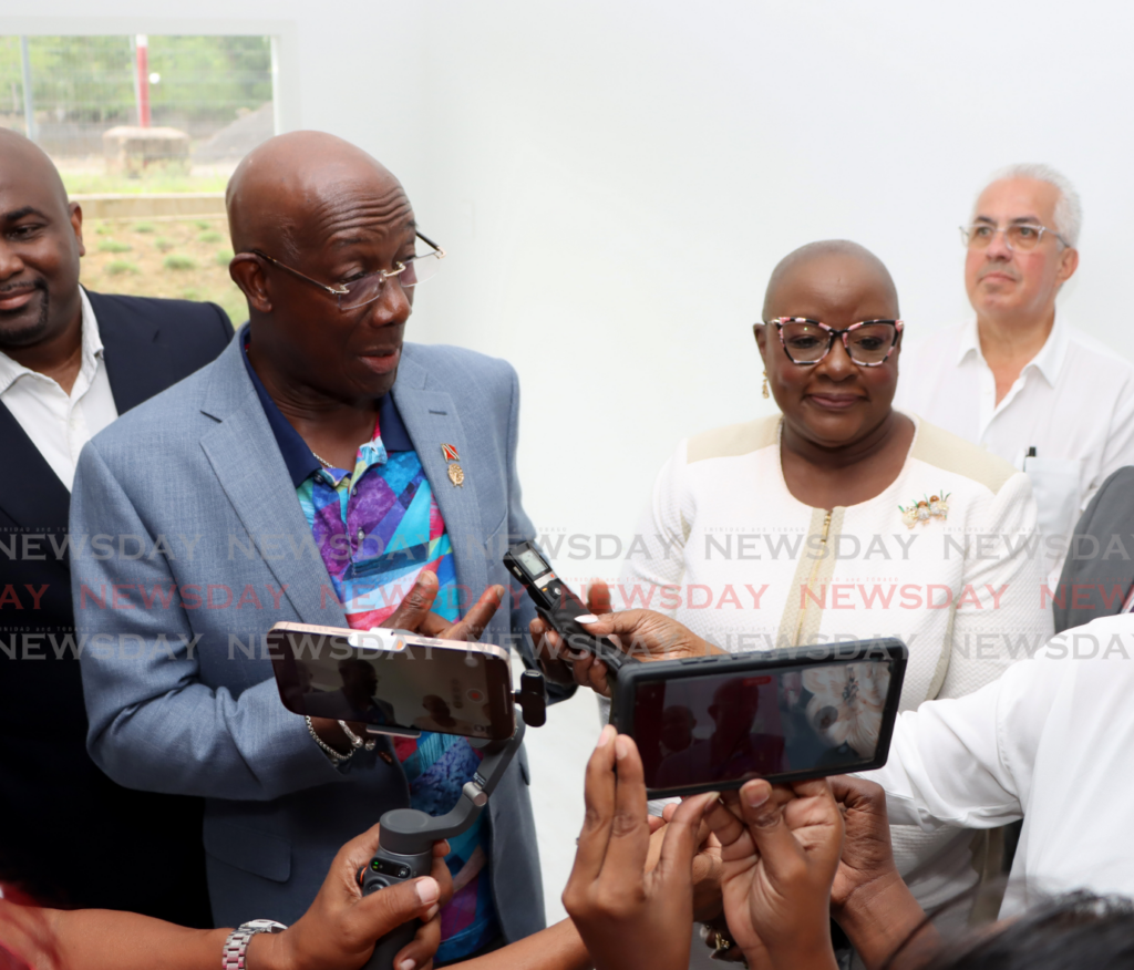 Prime Minister Dr Keith Rowley answers a question asked by Newsday reporter Yvonne Webb during the opening of the 90-apartment City Heights complex in San Fernando on February 6. - Photo courtesy Ayanna Kinsale