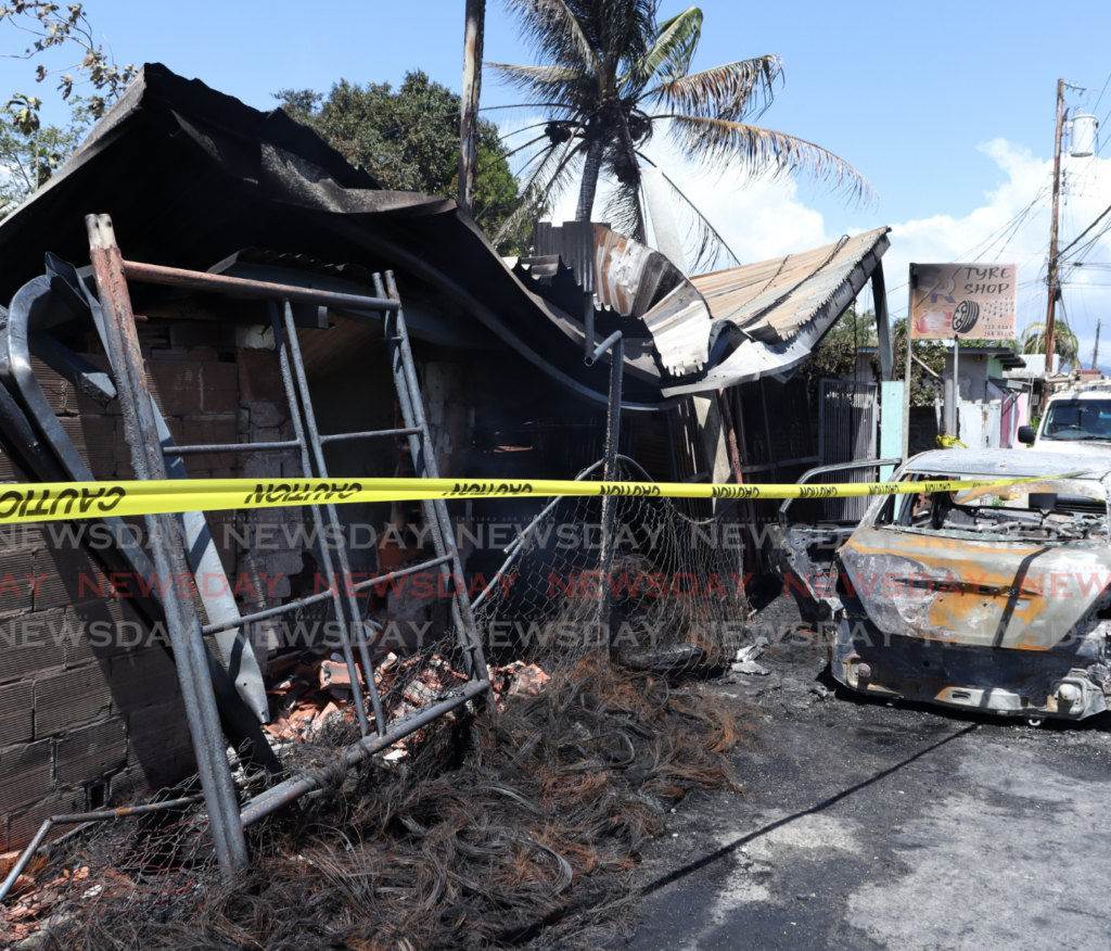 Two tyre shops, two cars and a house were completely destroyed and a neighbouring house damaged in a fire at Bridal Road, Chaguanas on February 8.  - Photos by Grevic Alvarado 