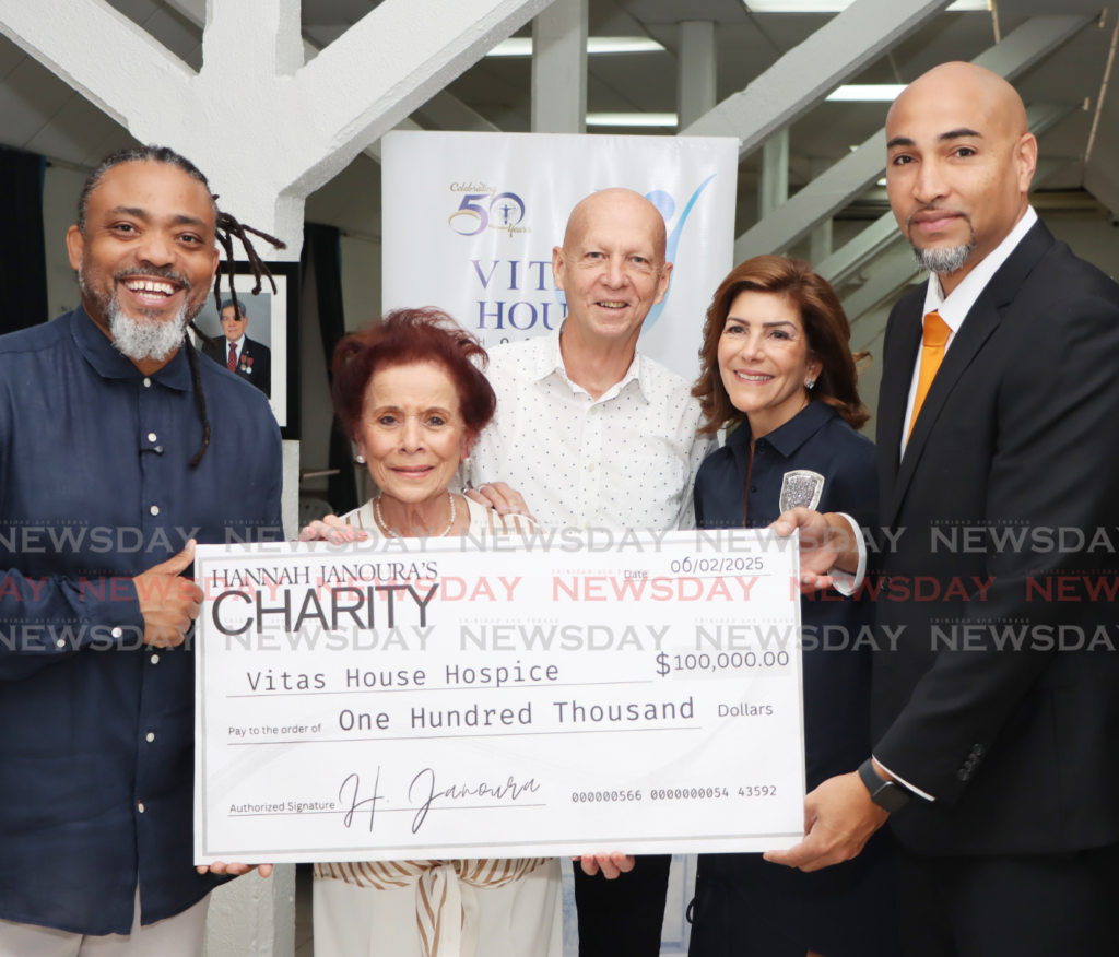 Businesswoman and philanthropist Hannah Janoura, centre, presents a cheque to chairman of the T&T Cancer Society Robert Dumas at Vitas House, Western Main Road, St James. Also in the photo are, Machel Montano, Brian Mac Farlane, and Gabrielle Azar. - Photo by Ayanna Kinsale