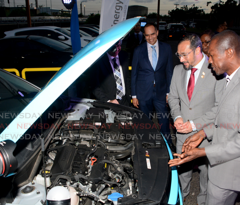 UWI engineering lecturer Dr Renique Murray, right, explains the M15 Fuel Blend on a car tested for its potential use to, from left, president of National Energy Dr Vernon Paltoo, president Methanex Trinidad Ltd Colin Bain, Energy Ministry PS Penelope Bradshaw Niles and Energy Minister Stuart Young at Methanex Trinidad Ltd, Point Lisas Industrial Estate, Couva, on February 6. - Photo by Innis Francis