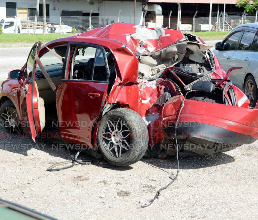 The mangled wreckage of a Nissan Tiida in which two teenaged boys died after an unlicensed driver crashed it in an attempt to escape police on the night of February 10. Police had chased the car after it failed to stop at a roadblock in Point a Pierre. - Photo by Innis Francis