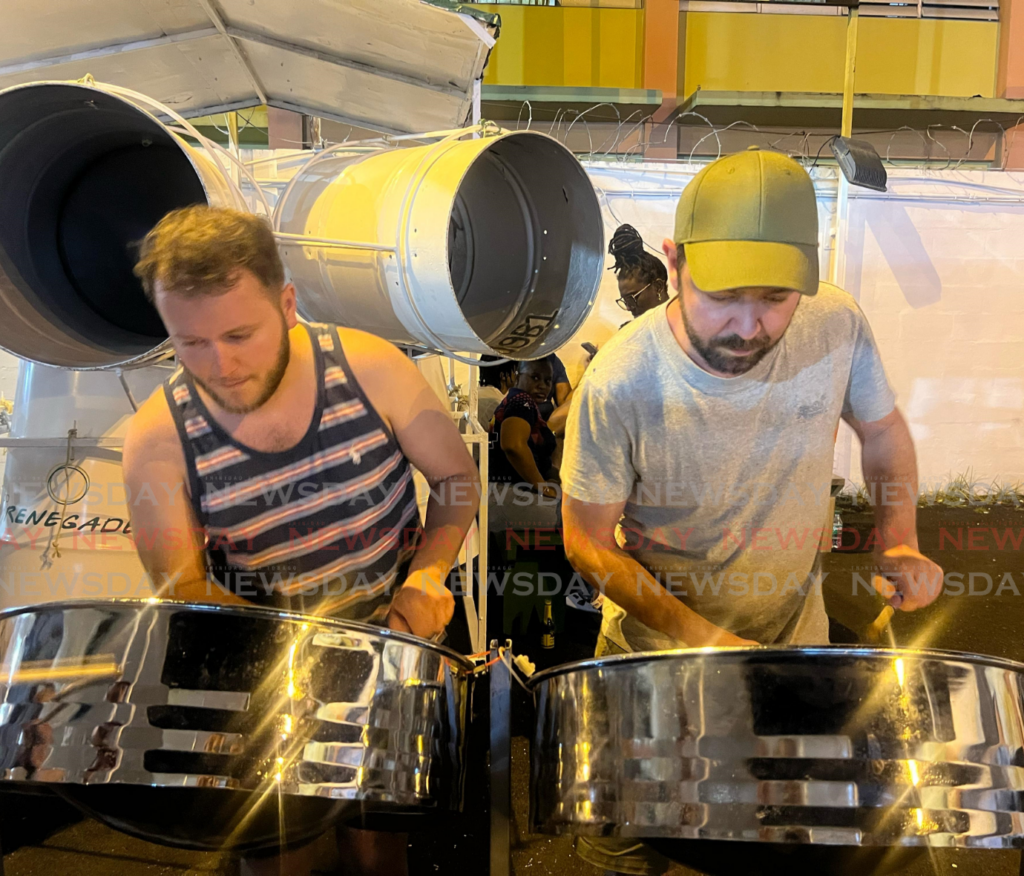 Vivien Duroy, left, and Axel Raimbault stike notes on the tenor pan at bp Renegades panyard on February 12 as the band prepares for the semifinal round of Panorama competition. - Photos by Enrique Rupert