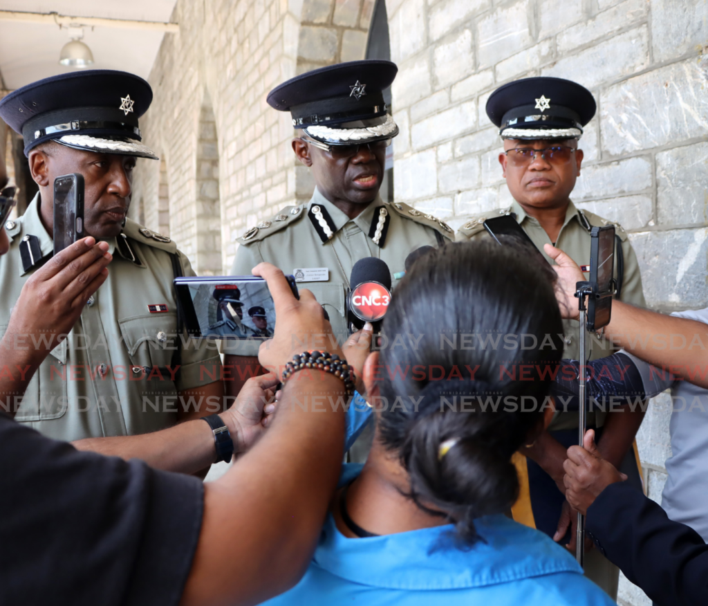 Acting CoP Junior Benjamin (centre) speaks to reporters outside the Police Administration Building on Sackville Street, Port of Spain on February 17. - Photo by Ayanna Kinsale