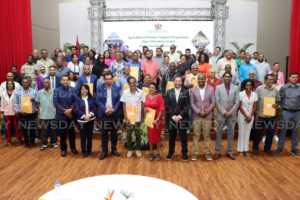 Minister of Energy and Energy Industries Stuart Young, sixth from right, takeas a photo with participants of the Agricultural Finance Support Programme at the NESC Auditorium, Rivulet Road, Point Lisas, Couva, on February 7. - Photo by Ayanna Kinsale