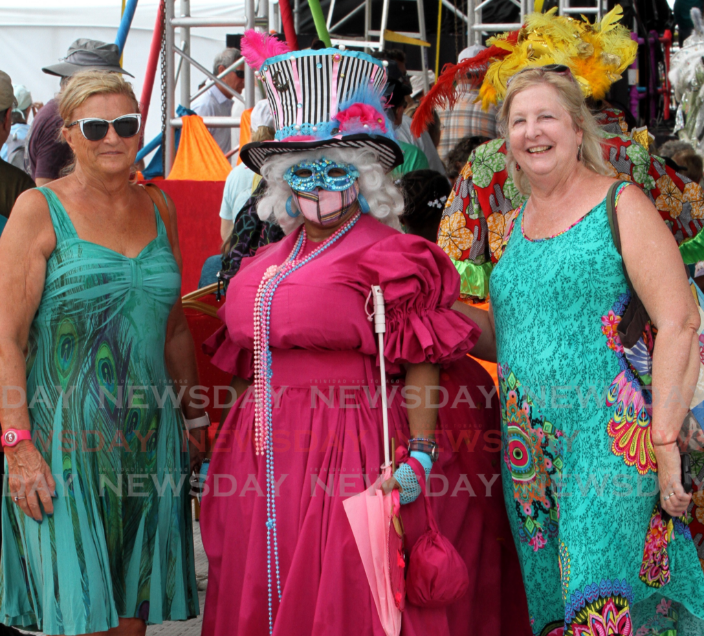 Diana Peter on left and Patti Stanley of Minnosota, USA, pose with a Dame Lorraine at Carnival Village, Queen's Park Savannah, in February, 2023. - File photo by Angelo Marcelle