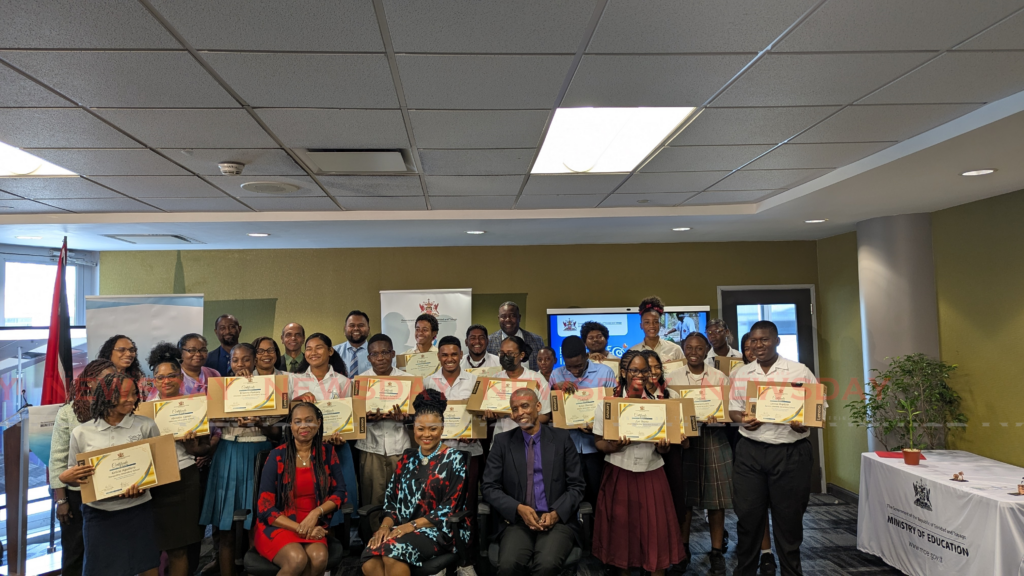 From left, Education Ministry permanent secretary Jacqueline Charles, Education Minister Dr Nyan Gadsby-Dolly and Chief education officer  Dr Peter Smith posing with the teachers, principals and students of the 20 schools recognised at the Excellence in Focus ceremony. - Photos by Mya Quamie