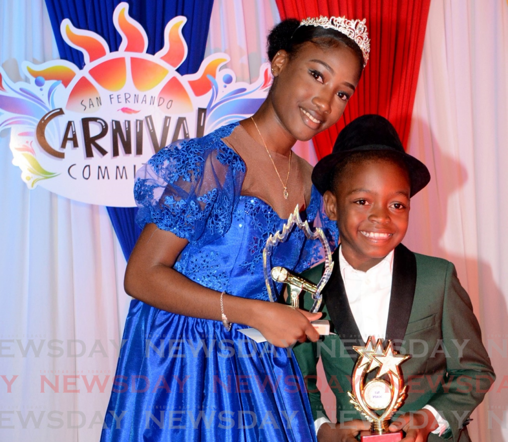 WINNER'S ROW: Jimecya Burnett and Xhaidan Darius, right, winners of the San Fernando Carnival Committee's secondary and primary schools calypso monarch competition respectively, with their titles at  San Fernando City Hall on Thursday. - Photos by Innis Francis 