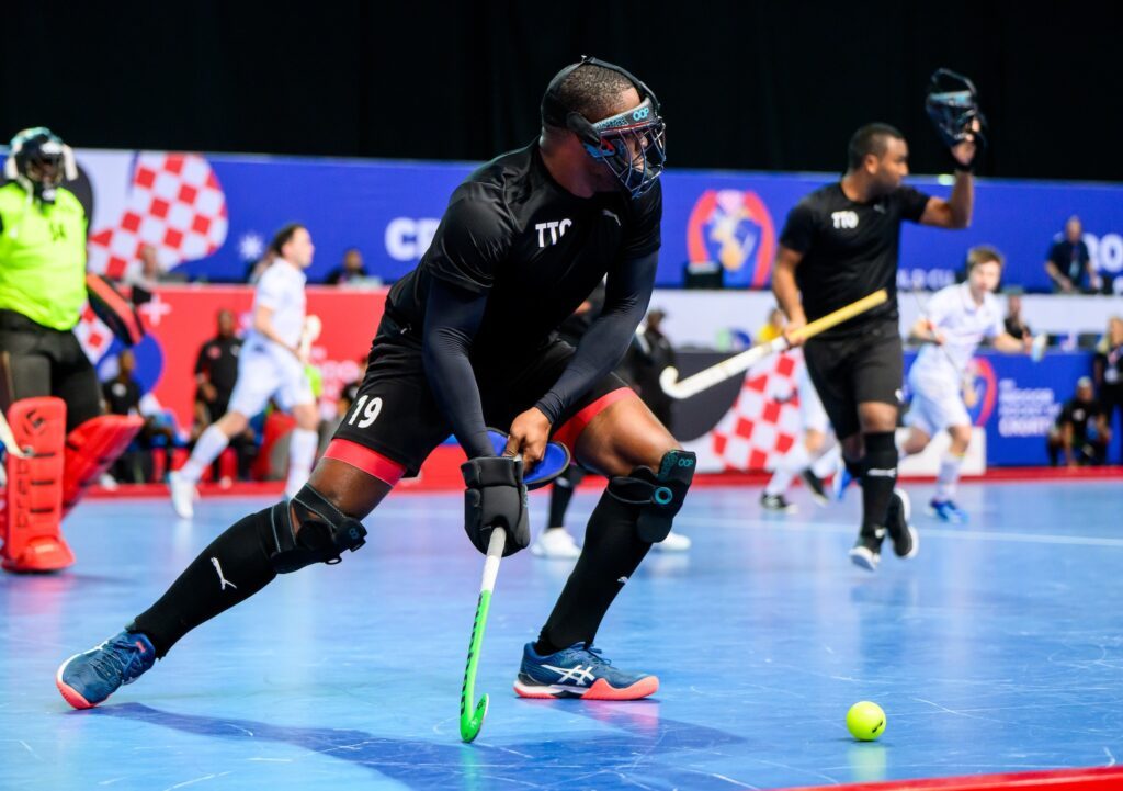 TT men's hockey player Shaquille Daniel looks to clear his lines after a penalty corner in the pool C FIH Indoor World Cup match versus Belgium in Porec, Croatia on February 6. Photo courtesy FIH