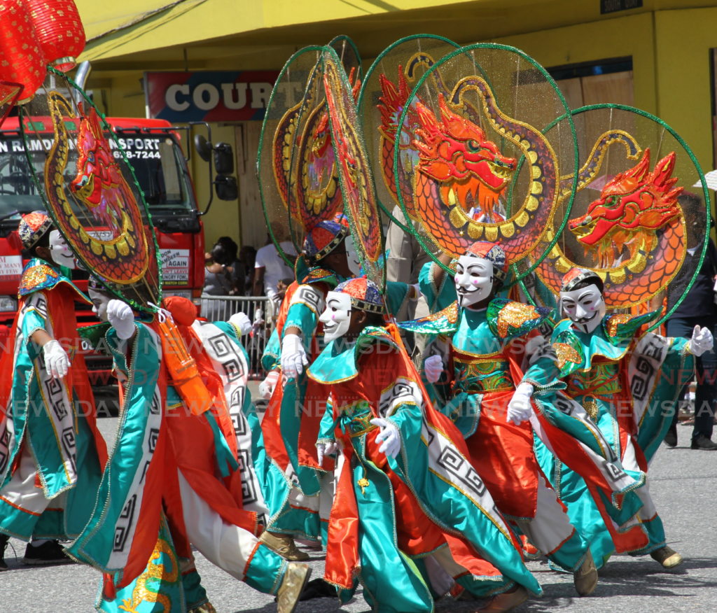 A group of young masqueraders where masks as part of their costumes during Carnival in 2018. - File photo