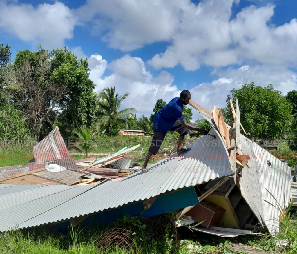 Ted Brown salvages belongings from the rubble of his demolished home in Ramjattan Trace, Arima.