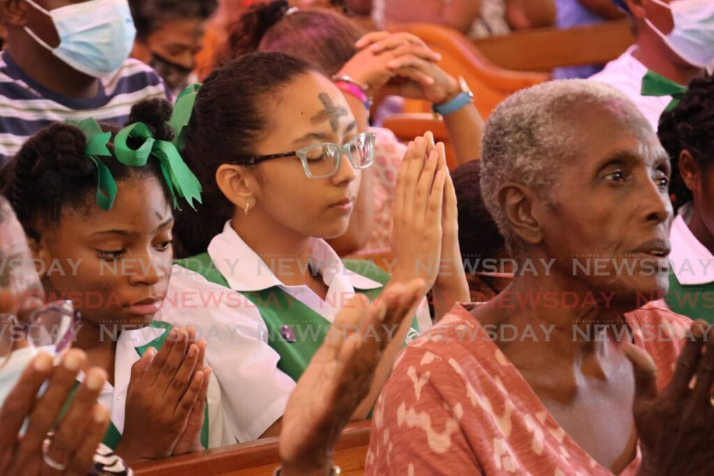 Students of St Gabriels RC in prayer during Ash Wednesday Mass at Our Lady of Perpetual Help, San Fernando on February 14, 2024. - File photo by Lincoln Holder