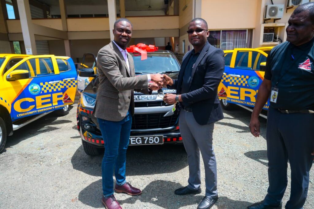 Chief Secretary Farley Augustine, left, presents the keys to three new vehicles to Tobago Emergency Management Agency official Gerald Layne in 2024. - File Photo