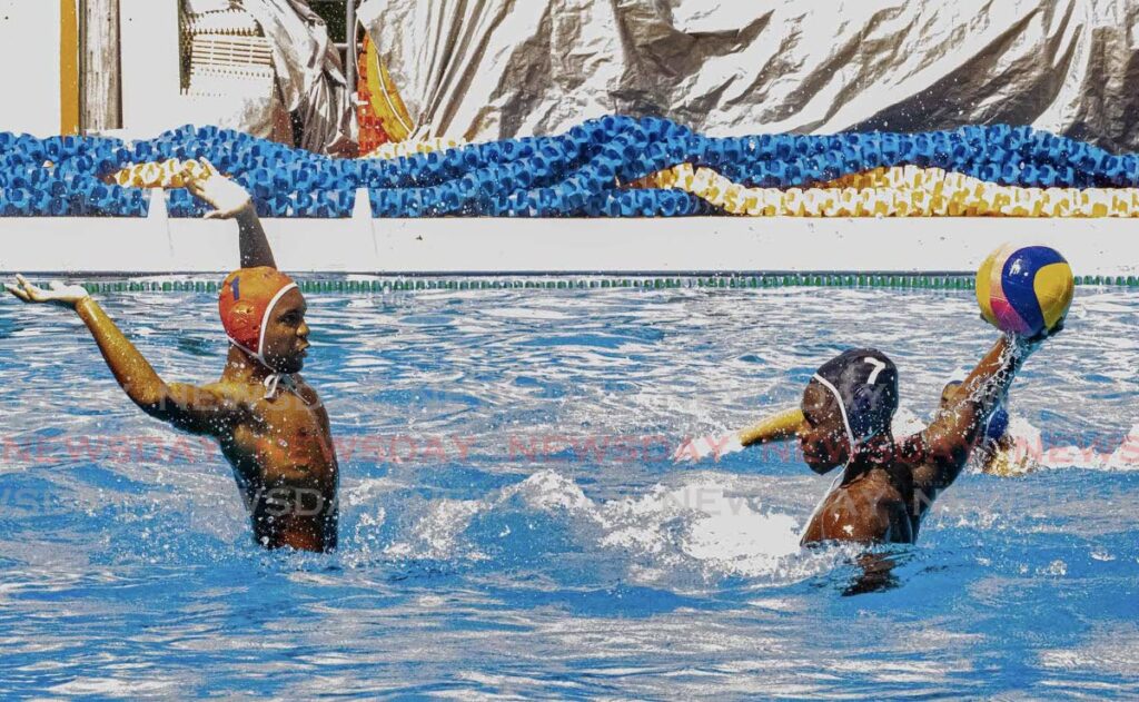 St Mary's College's Evan Gillard-Bruce (right) shoots as Fatima College goalkeeper Josiah Cumberbatch makes himself big during their clash in the open category of the Secondary Schools Water Polo League at the National Aquatic Centre, Couva on February 8. - Photo courtesy Cindy-Lou Valentine