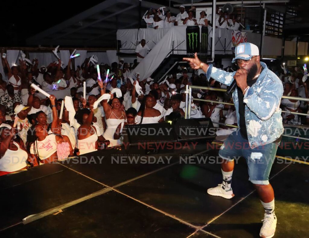 Bunji Garlin performs his mega hit Carry It during a Carnival fete.  - Photo by Angelo Marcelle