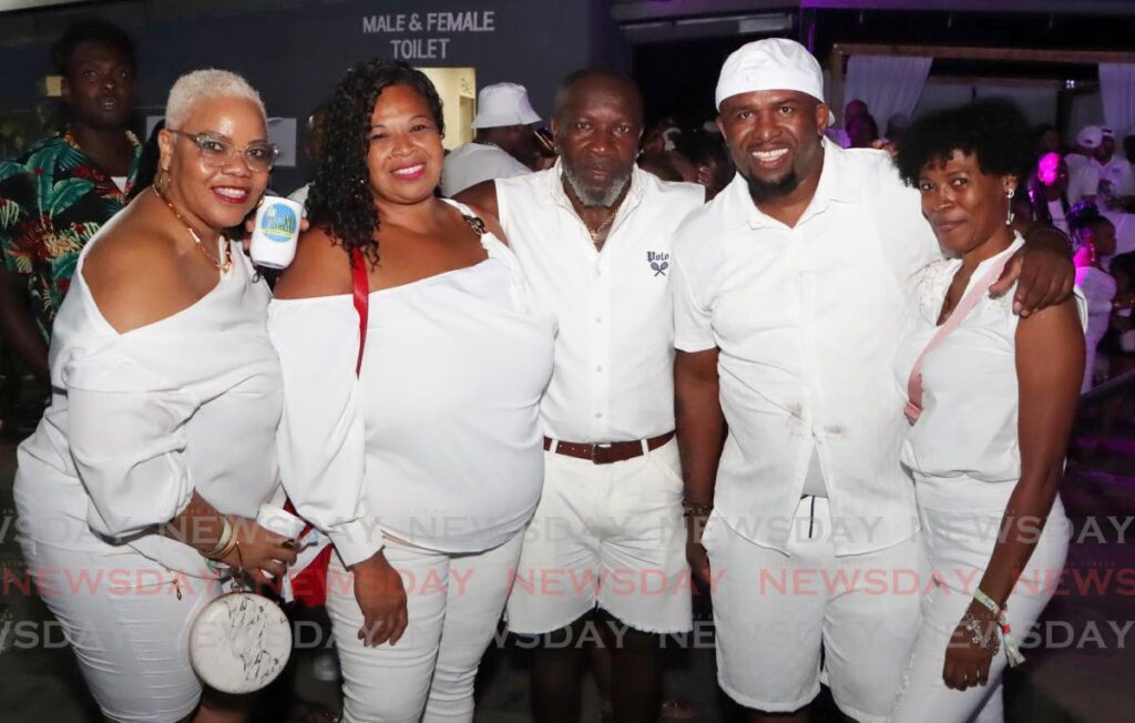 One Arima International promoter JT, second from right, with some friends at InDiGlo. - Photo by Angelo Marcelle