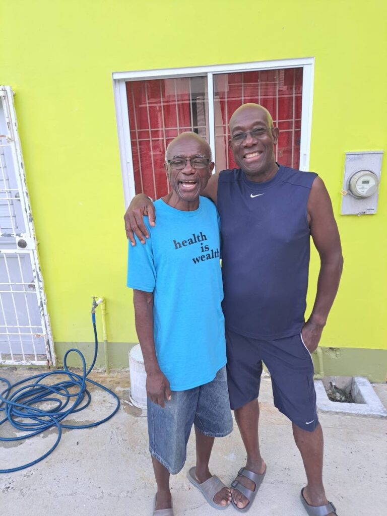 The Prime Minister and his close friend and former classmate Selwyn Pilgrim enjoy a light moment.  - Photo courtesy Selwyn Pilgrim