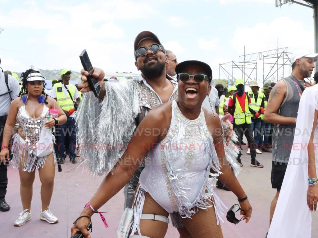 Creative director and bandleader of the Lost Tribe Valmiki Maharaj enjoys himself with a friend during the parade of the bands on Carnival Monday at the Queen's Park Savannah, Port of Spain.  The Lost Tribe copped the band of the year award.  - Photo by Ayanna Kinsale