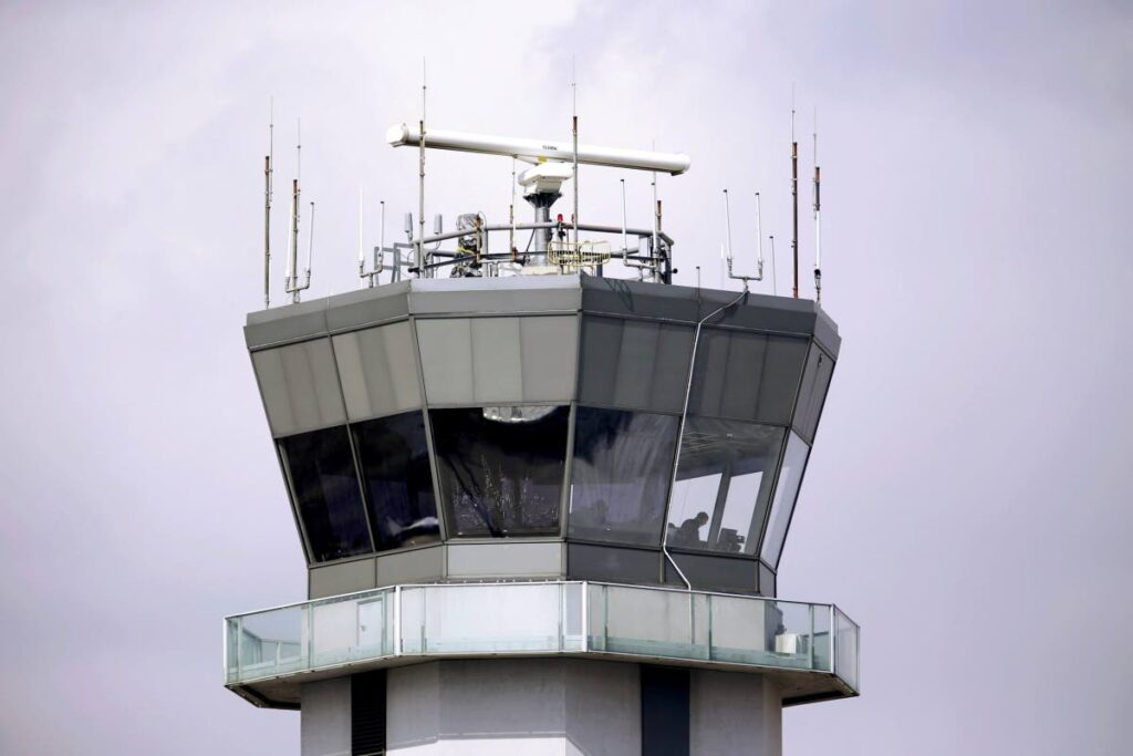 The air traffic control tower stands at Chicago's Midway International Airport.  On February a Southwest Airline plane executed a go-around to avoid collision with another plane. - Photo via AP   