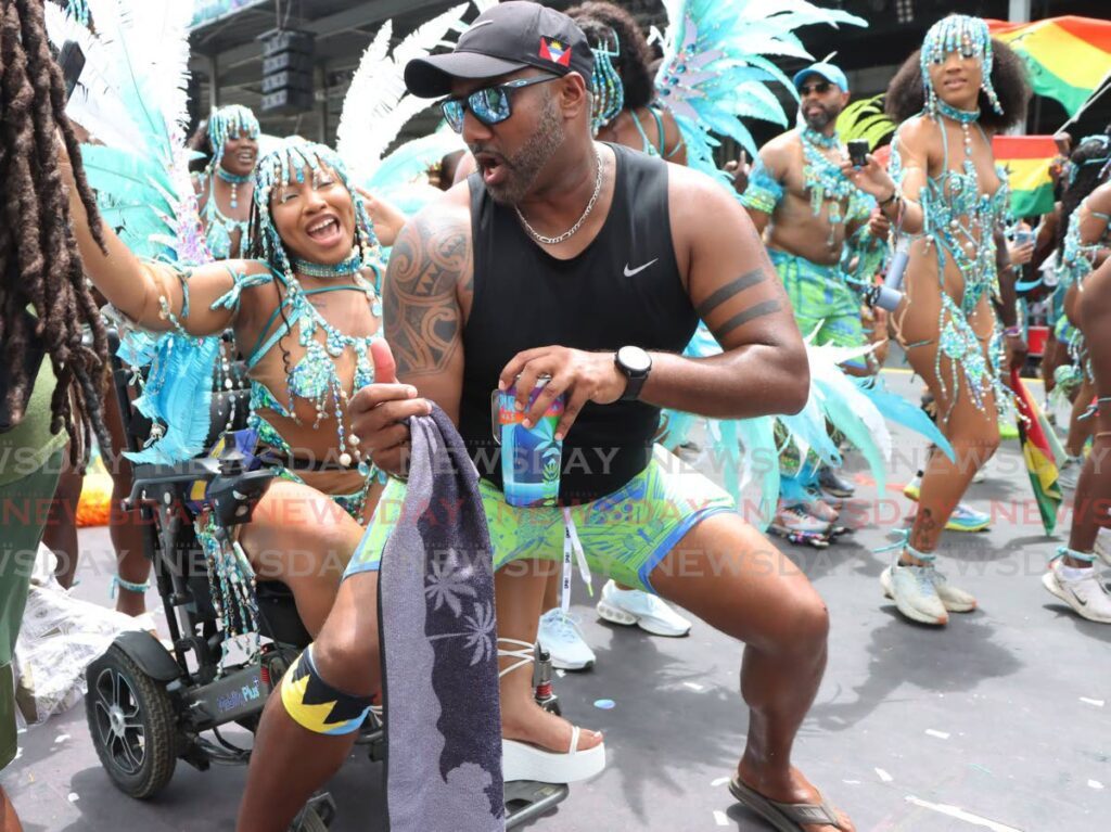 Janae Downer has fun with a friend in Spirit Mas during the parade of the bands on Carnival Tuesday at the Queen’s Park Savannah, Port of Spain.   - Photo by Ayanna Kinsale