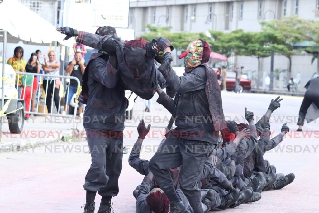 The masked Central Elite were the first to parade in front of the judges of the Chaguanas Carnival Committee on Ramsaran Street, Chaguanas on Carnival Tuesday afternoon. - Photo by Grevic Alvarado