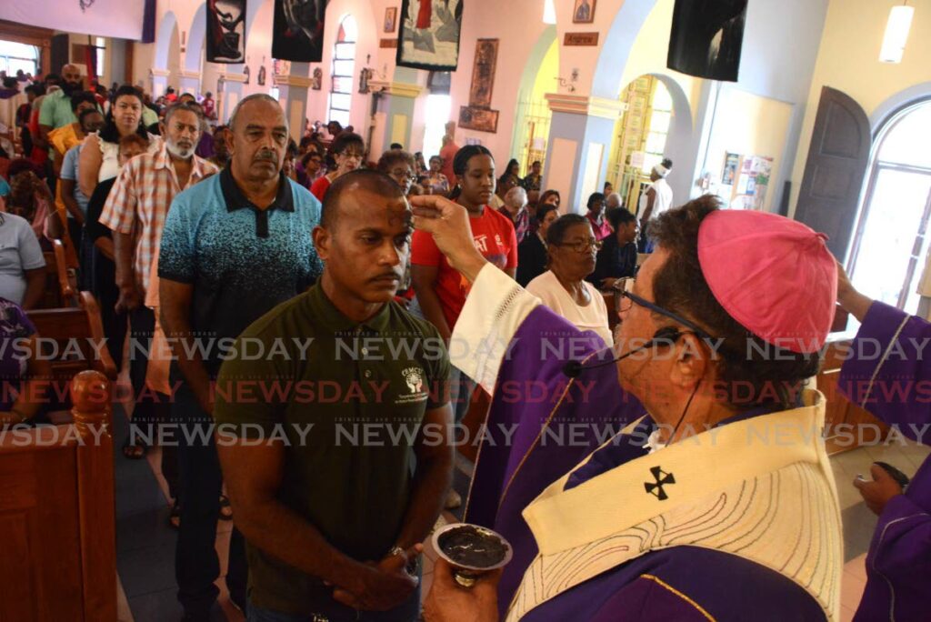 Roman Catholics line up to receive ashes from Archbishop Jason Gordon at Ash Wednesday mass at Our Lady of Perpetual Help RC Church at Harris Promenade, San Fernando, on March 5. - Photo by Innis Francis