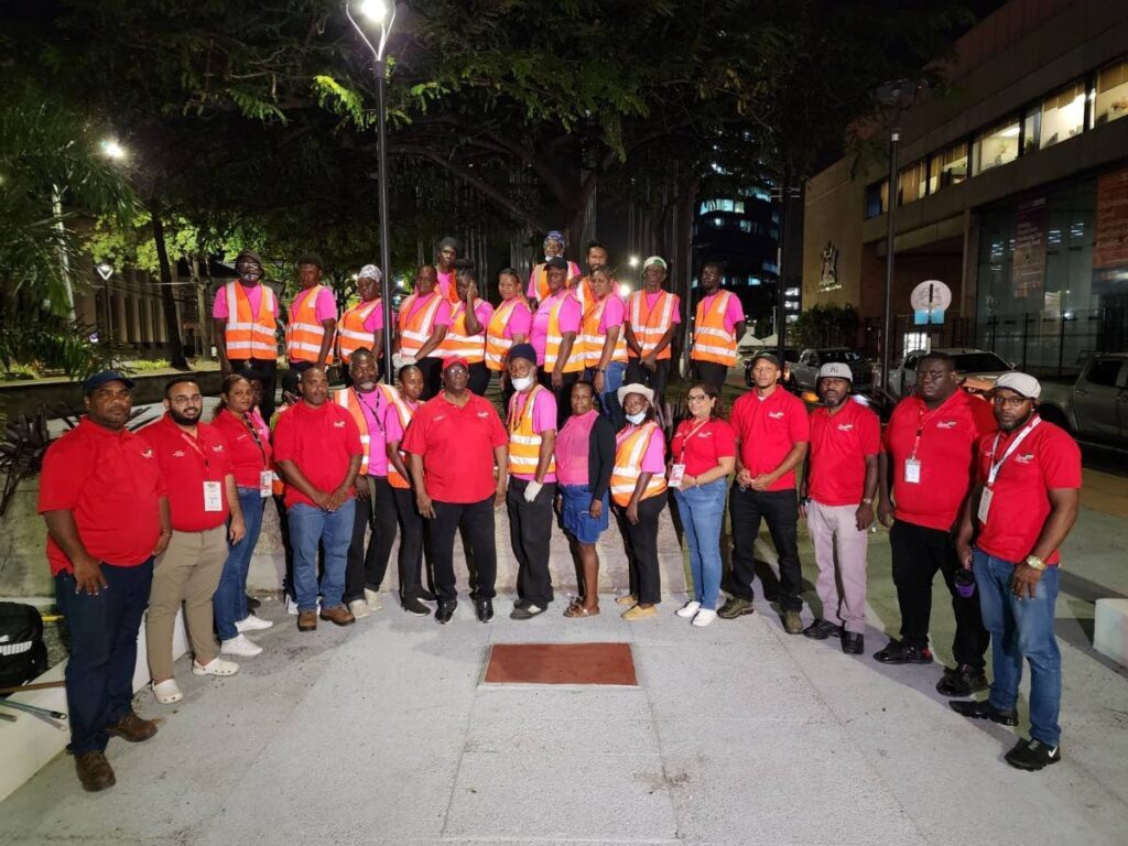 CEPEP Company CEO, Keith Eddy, centre front, flanked by staff and contractors’ workers on the Brian Lara Promenade after clean up exercised on Ash Wednesday morning. - Photo courtesy CEPEP