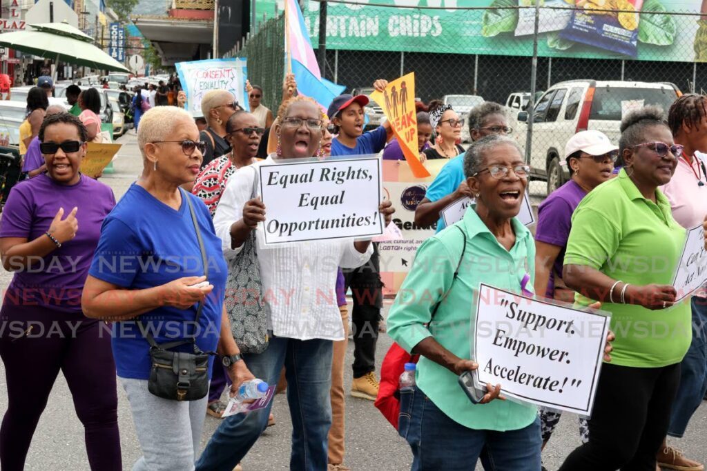 Women march along Frederick Street, Port of Spain, in celebration of International Women's Day on March 8.  - Photo by Faith Ayoung