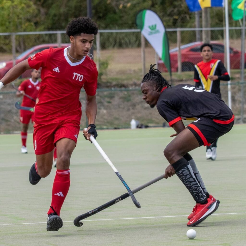 TT's Andrew Mohammed, left, vies for possession against Guyana during their 2025 Jr Pan American Challenge match, on March 10, at the Sir Garfield Sobers Complex, Wildey, St Michael, Barbados. - Photo courtesy PAHF