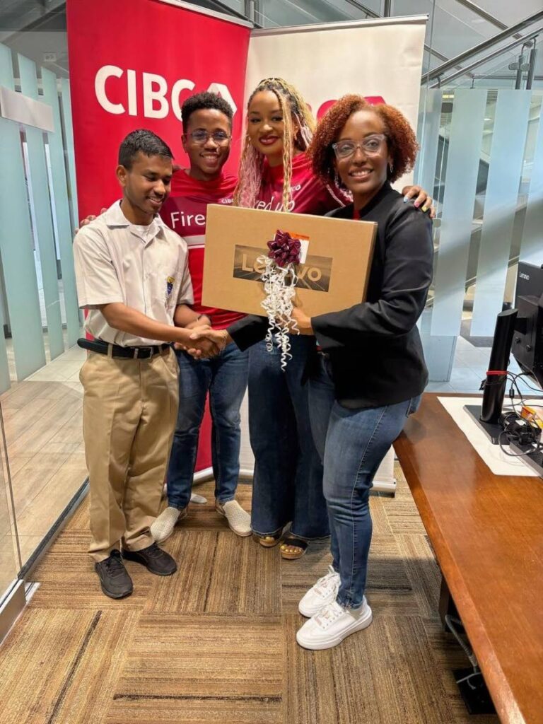 Neeraj Seemungal, a student at Fatima College, receives a laptop as his prize for participating at the CIBC booths during The UWI’s Math Fair. Making the presentation are from right, Valarie Zephyrine, product expert, deposits - personal & business banking; Sarah Rudder Chulhan, associate director, digital client experience; and Jodhan Medina, data scientist. - 