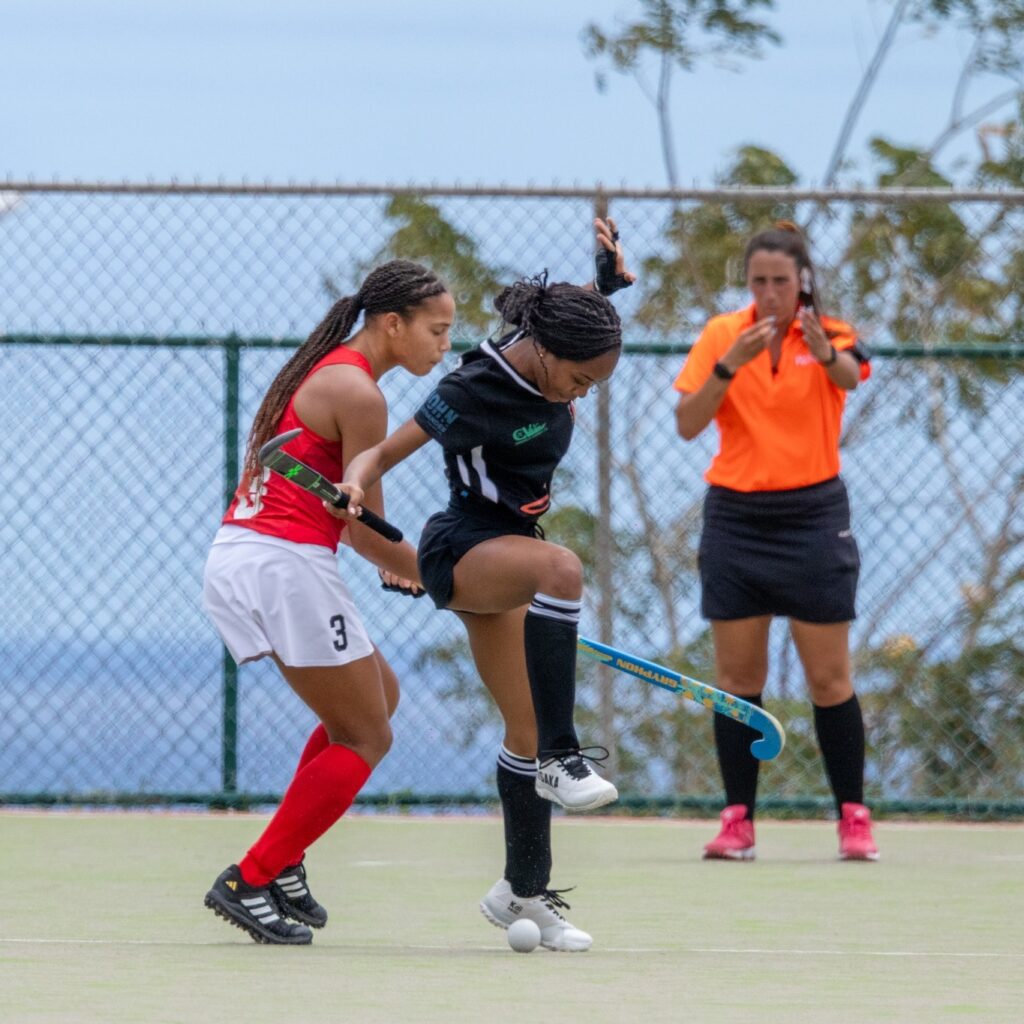 Daniella Douglas of TT, left, battles for the ball against a Guyanese opponent at the 2025 Junior Pan Am Challenge in Barbados. Guyana won 1-0.