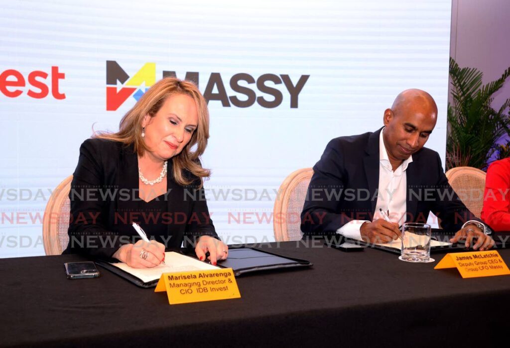 Marisela Alvarenga, managing director of IDB Invest, left, and James McLetchie, deputy CEO of Massy Group, sign a US$150 million agreement between IDB invest and Massy Group at the Hyatt Regency, Port of Spain on March 17.  - Photo by Faith Ayoung