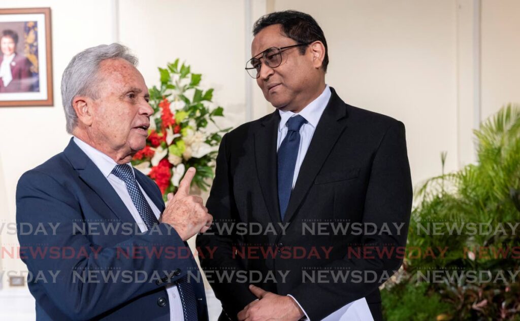 FINANCE TIPS: Newly appointed Minister of Public Utilities Colm Imbert, left, speaks to Minister of Finance Vishnu Dhanpaul at President's House, St Ann's on March 17 - Photo by Jeff K Mayers