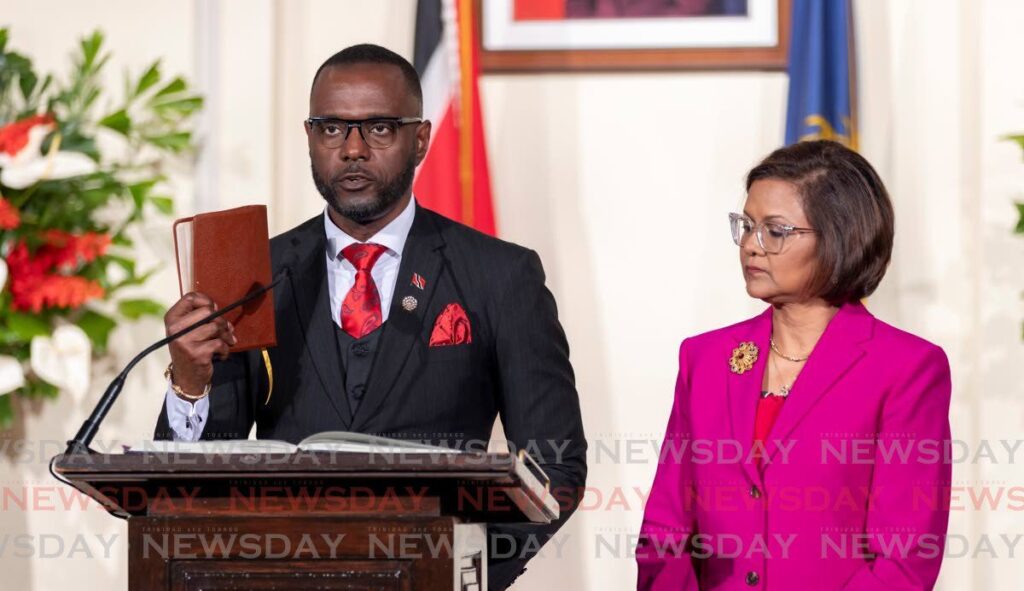 Marvin Gonzales takes the oath of office as the new Minister of National Security at the President's House, St Ann's, on March 17. - Photo by Jeff K Mayers