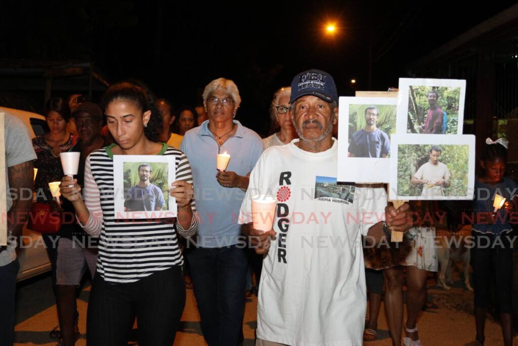 FOR JAVED: Friends, neighbours and relatives of Javed Omardeen held a candlelight vigil in his memory at Madamas Road, Brasso Seco, on March 18. Omardeen, a cocoa farmer, was murdered close to his home on March 14.     - Photo by Faith Ayoung