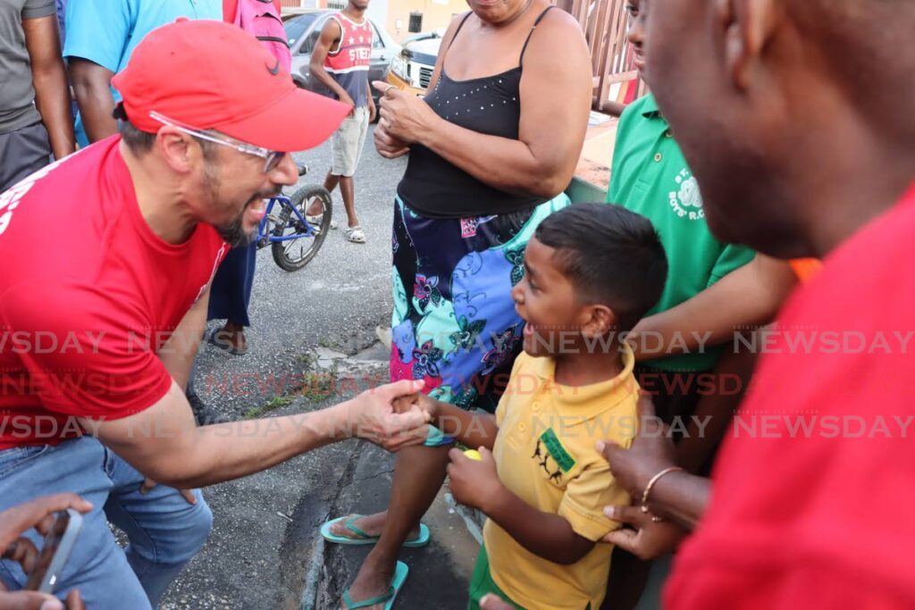 YOUNG MEETS YOUTH: This youngster was excited to meet Prime Minister Stuart Young in Tunapuna on March 20. Young and incumbent MP Esmond Forde went on a 