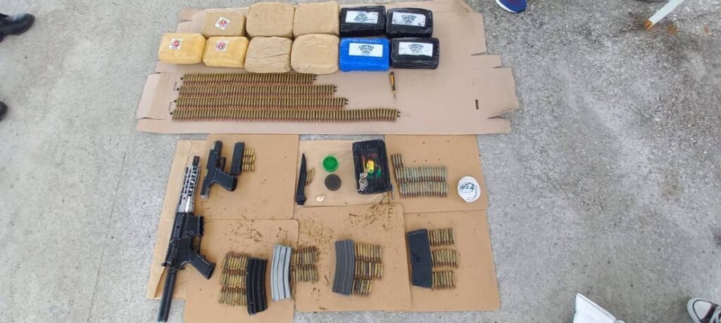 Firearms, ammunition and narcotics Seized by police during a drug operation in Claxton Bay on March 20. - 