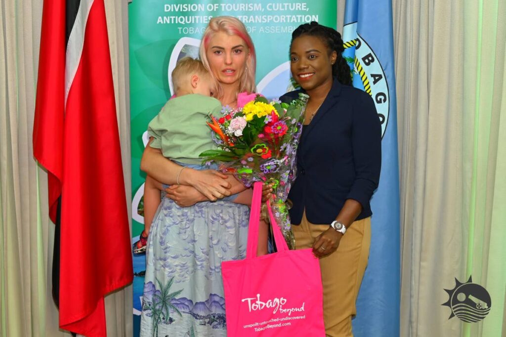 Secretary of Tourism Tashia Burris, right, with Swedish visitor Sarah Persson at a function to honour those who played a role in saving the life of CAL pilot Christon Battersby. - Photo courtesy THA 