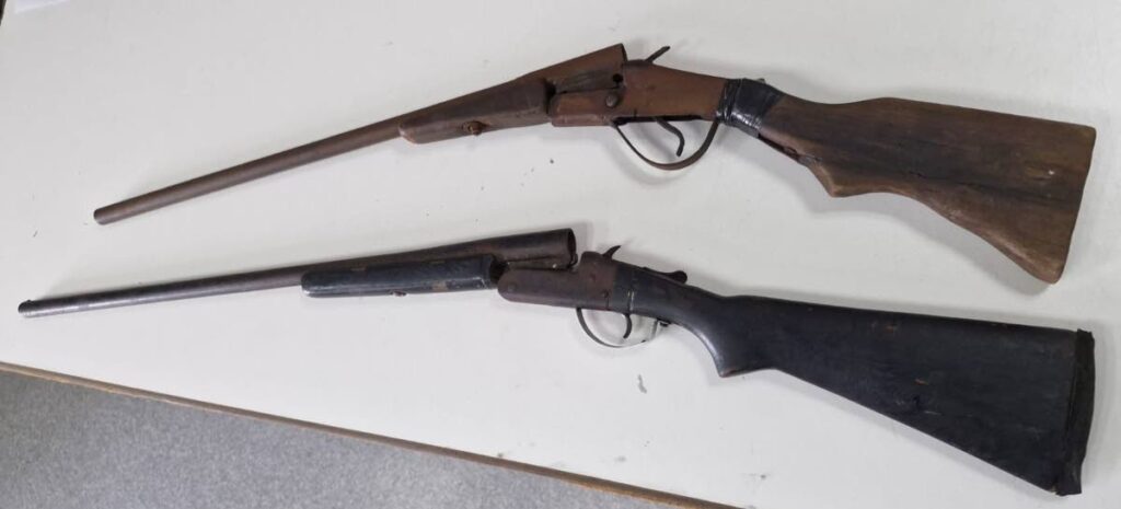 Two shotguns seized by police in a camp off Dump Road, Arima. - Photo courtesy TTPS