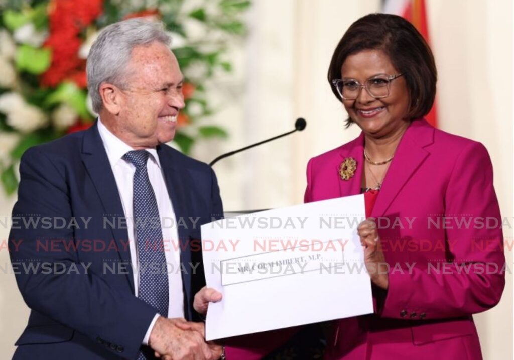 Colm Imbert accepts his instrument of appointment from President Christine Kangaloo at the President's House, St Ann’s on March 17. - Photo by Jeff K Mayers