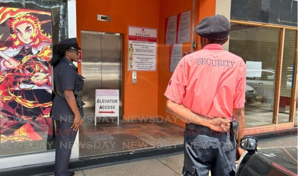 Police and mall security officers at Carlton Centre stand guard at an access point after a suspected bandit entered the building. - Photo by Rishard Khan